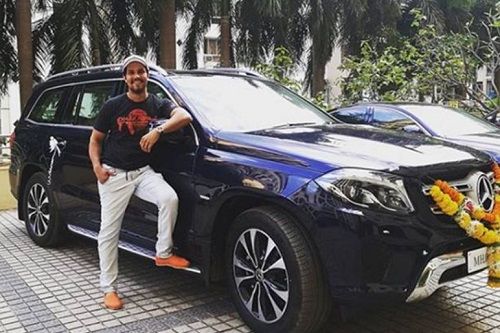 Randeep Hooda posing with his Mercedes-Benz GLS car