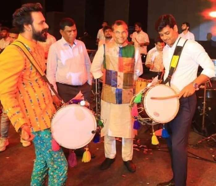 Shrikant Shinde playing the drums at an event in Mumbai