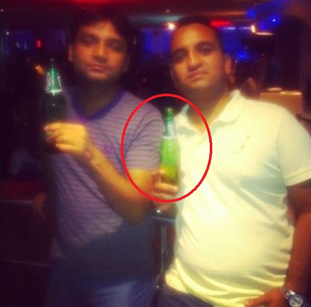 Arun Yadav holding a bottle of beer