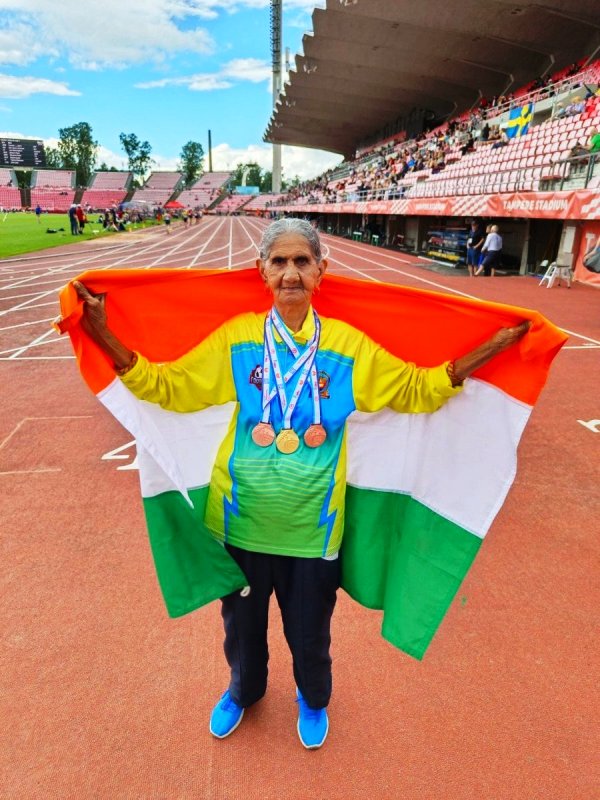 Bhagwani Devi holding the national flag during the World Masters Athletic Championships in Finland