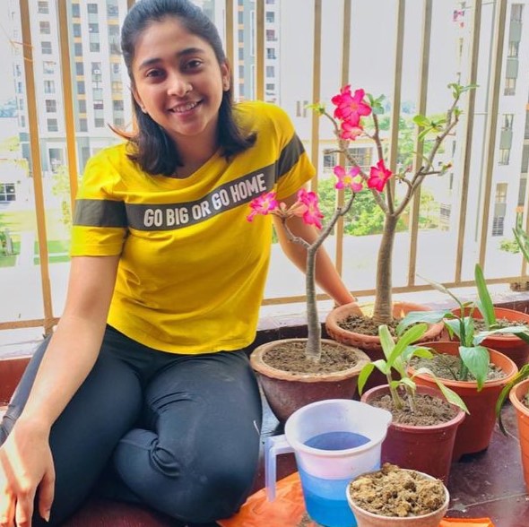 Mehuli Ghosh while planting sapling at her home