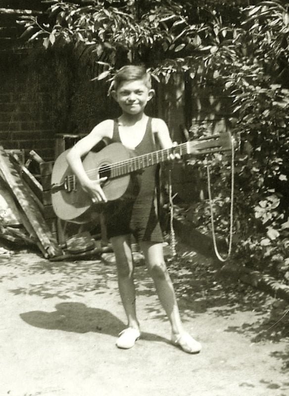 Monty Norman with his guitar when he was little