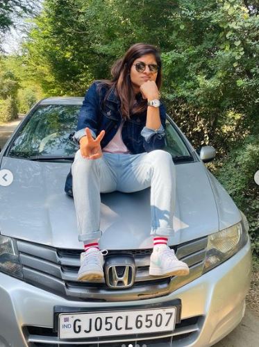 Radha Yadav posing with her car