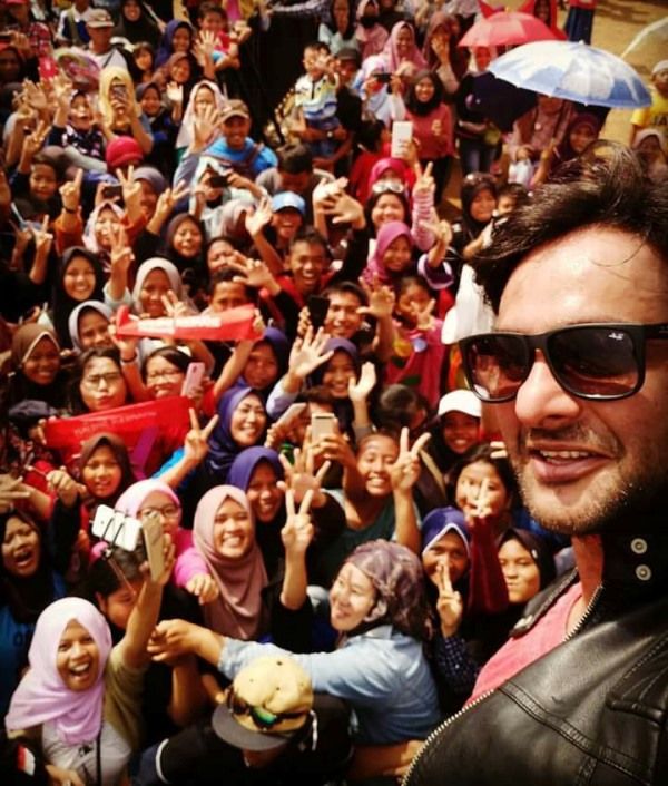 Rohit taking a picture with his fans in Indonesia