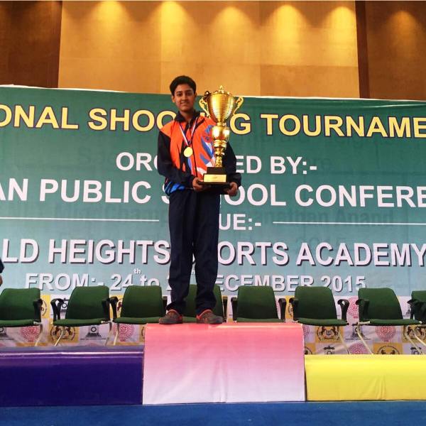 Shahu Mane holding a trophy after winning Zonal Shooting Tournament