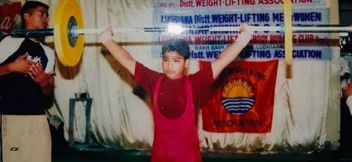 A childhood picture of Vikas Thakur in a weightlifting competition