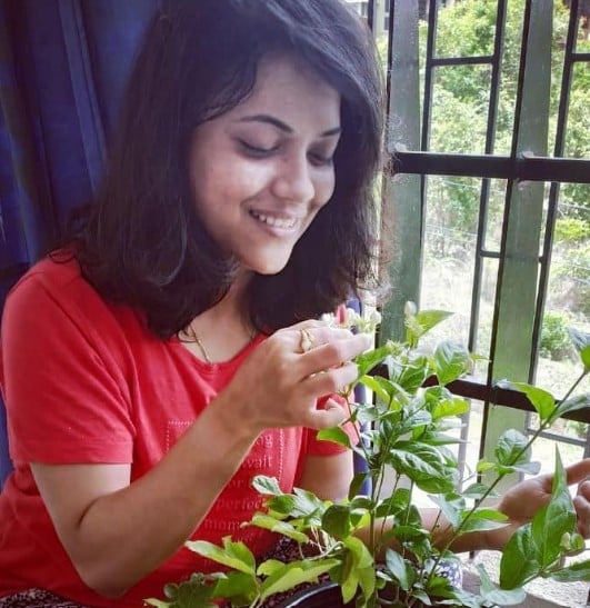 Bhakti Kulkarni planting a sapling at her home