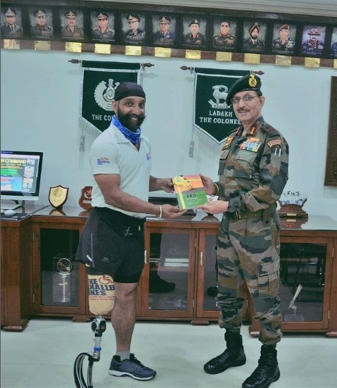 Major DP Singh while handing over a copy of his book to Lt Gen YK Joshi, former Indian Army Commander