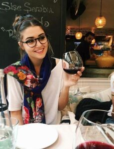 Hande Ersel holding a glass of wine