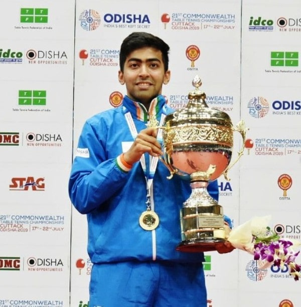 Harmeet Desai holding his trophy and medal after winning the Commonwealth Championship's table tennis event