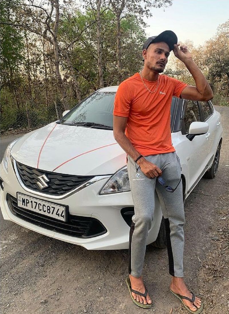 Kuldeep Sen posing with his car