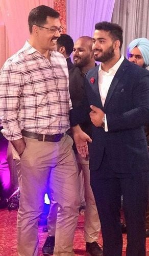 Vikas Thakur with his coach Vijay Sharma