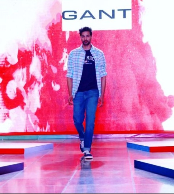 A photo of Raja Shekar walking down the ramp while modelling for GANT