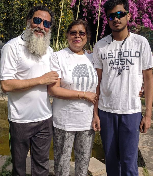 A picture of Anil George with his wife and son