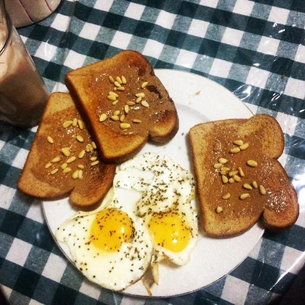 Breakfast cooked by Yashica Dutt - Sunny side on the top and toasts covered with almond butter and peanuts