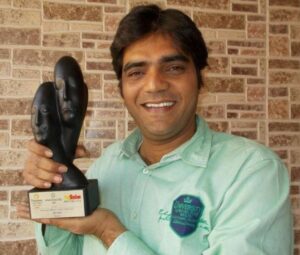 Dipen Raval posing with his Best Supporting Actor Award for the play Chitralekha in Mumbai