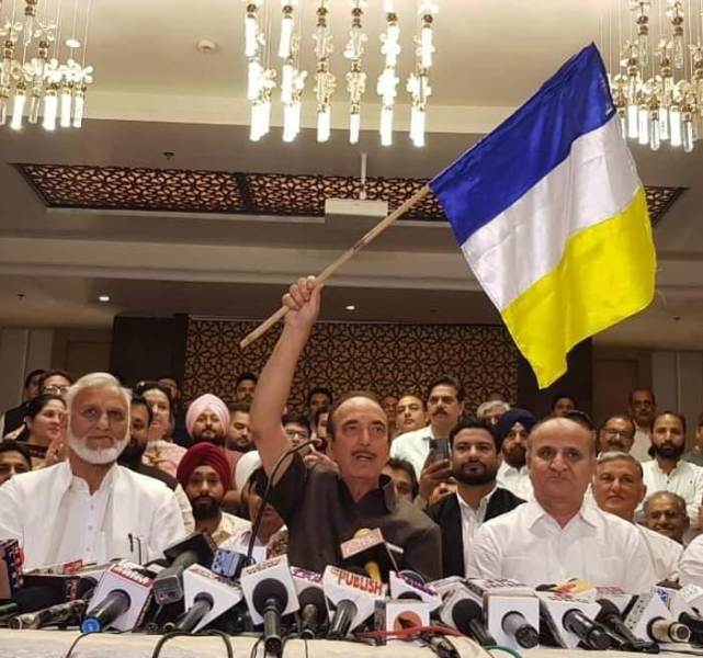 Ghulam Nabi Azad holding the flag of his new political party, Democratic Azad Party