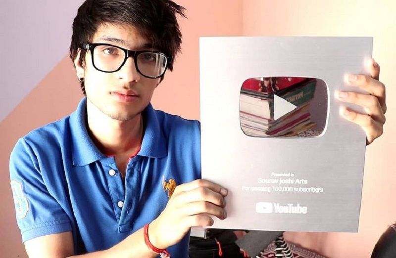 Sourav Joshi with his silver button from YouTube for his channel 'Sourav Joshi Arts'