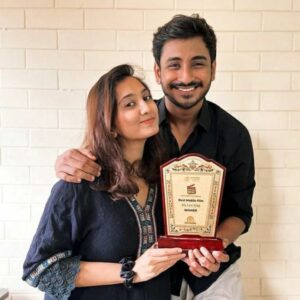 Short film My Last Vlog.  Utsav Sarkar posing with the award for Best Mobile Film