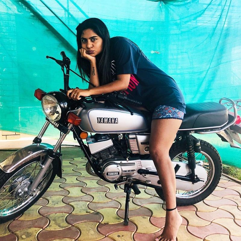 Deepika Das posing on her bike