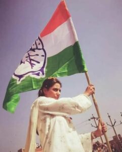 Divya Maderna holding the party flag of the Indian National Congress