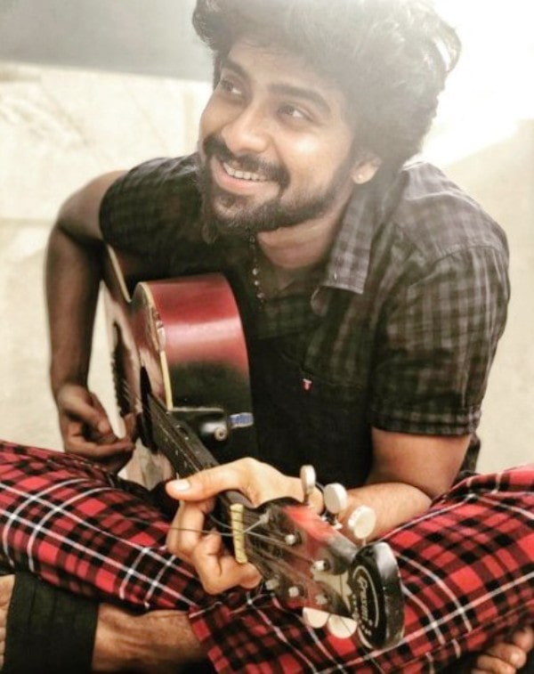 A photo of VJ Kathirravan taken while he was playing the guitar
