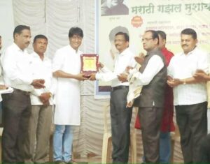 Kiran Mane posing with his Gadima Mandeshi Award award by Aadhar Foundation