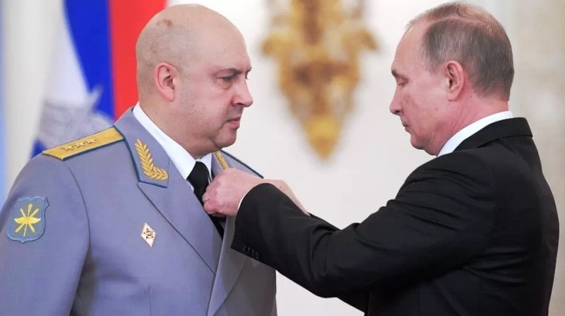 President Vladimir Putin pinning a medal on the chest of General Sergei Surovikin