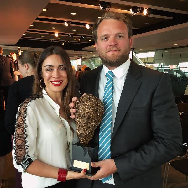 Ramita Navai, along with Patrick Wells, posing with the Robert F. Kennedy Journalism Award for 'Iraq Uncovered'