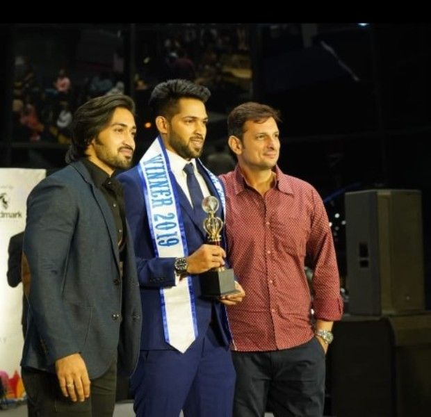 Rohit Shinde (centre) after winning the title of Mr India Man of the Globe 2019