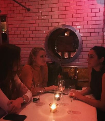Romina Pourmokhtari with her friends at a restaurant