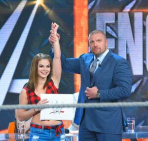 Sara Lee, along with Triple H, posing after winning the Tough Enough competition