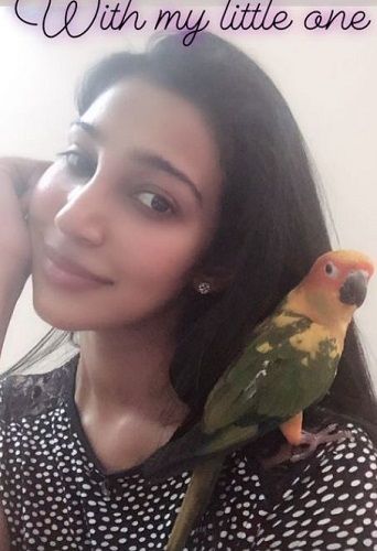 Sheriina Sam with her pet parrot