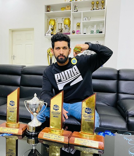 Sikandar Raza with his medals and trophies