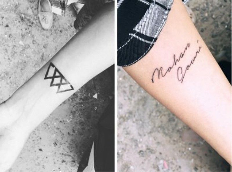 A Valknut tattoo inked on her right wrist and her parent's name inked on her left forearm