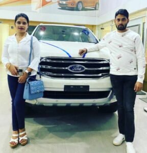 Archana Nag, along with her husband, Jagabandhu Chand, posing with her brand new car, Ford Endeavor