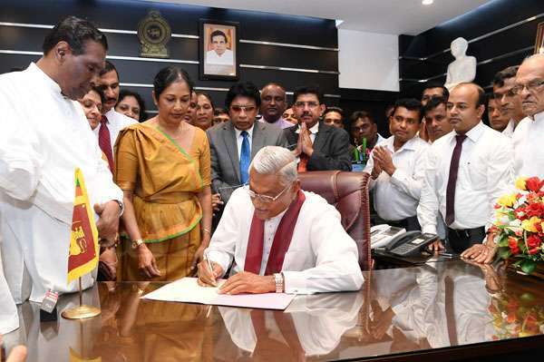 Chamal Rajapaksa's photo taken while he was signing the document after being appointed the Minister of Health, Nutrition, and Indigenous Medicine
