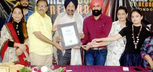 Jaswant Singh Gill receiving a cetificate from the World Book of Records
