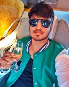 Nikhil Siddhartha holding a glass of champagne