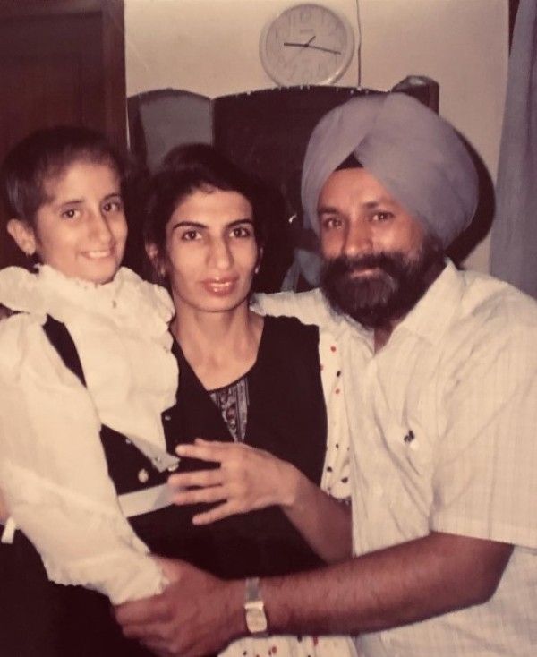 A childhood photograph of Guneet Monga with her parents