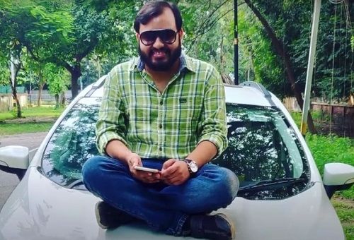 Alakh Pandey sitting on his Ford EcoSport car