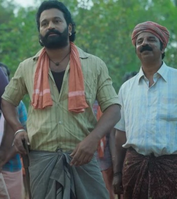 Prakash Thuminad (right) in a still from the film 'Kantara'