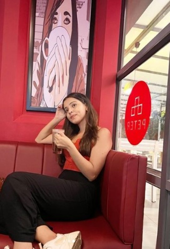 Richa Rathore posing with a glass of beer
