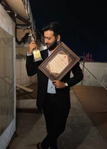 Siddharth Amit Bhavsar posing with his award for Best Singer Male - Critics Choice at the Film Excellence Awards Gujarati 2021