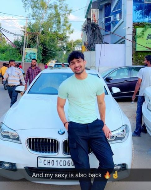 Abhishek posing with his BMW