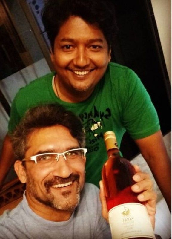 Ajit Shidhaye holding a bottle of wine