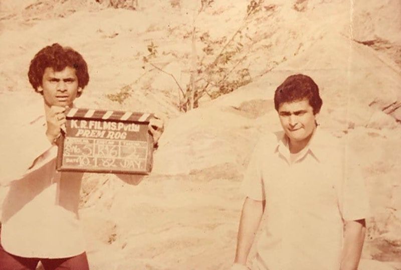 Azeem Bazmee (left) with the Indian actor Rishi Kapoor while assisting the director for the Bollywood film Prem Rog (1982)