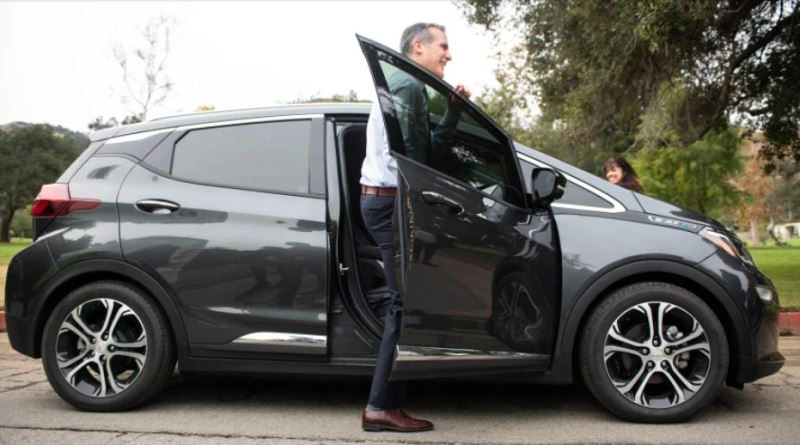 Eric Garcetti getting out of his Chevrolet Bolt