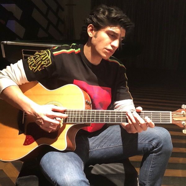 Karan Mehta playing guitar