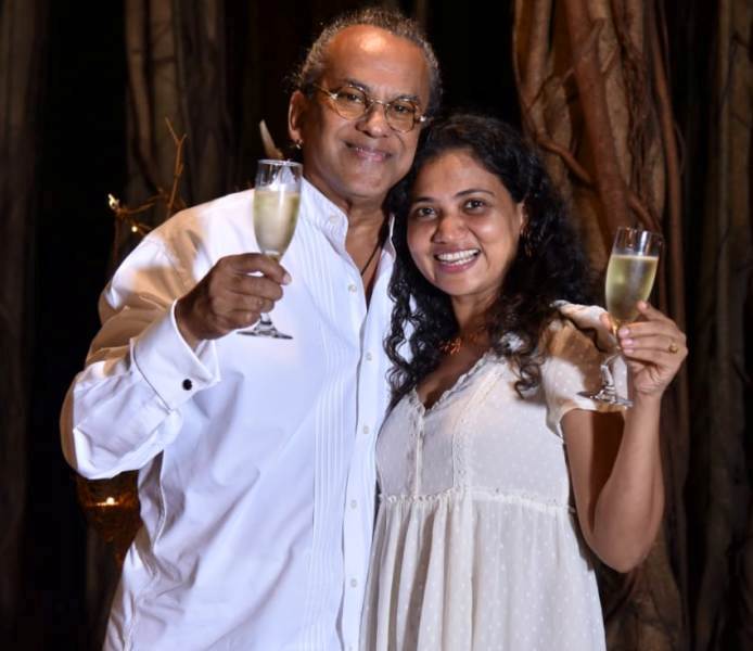 Remo Fernandes holding a glass of champagne